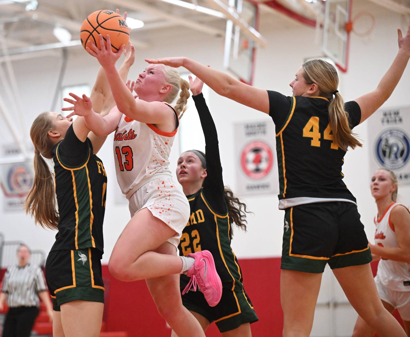 St. Charles East's Addie Schilb drives to the basket against, from, left, Fremd's Anna Montella, Gracie Todd and Sophia Adams during the Grow the Game Showcase at Deerfield High School on Saturday, Jan. 3, 2026 in Deerfield.