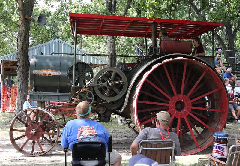 The biggest steam powered tractor in the parade makes its way by the grand stand Thursday, Aug. 7, 2025, during the 68th annual Sycamore Steam Show and Threshing Bee at Taylor Marshall Farm on Lukens Road in Sycamore.