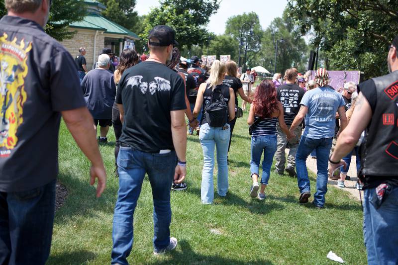 Bikers at the  9th Annual Ride for John walk hand in hand to the remembrance wall for my child's life matters on Saturday Aug.2, 2025 in Carol Stream.