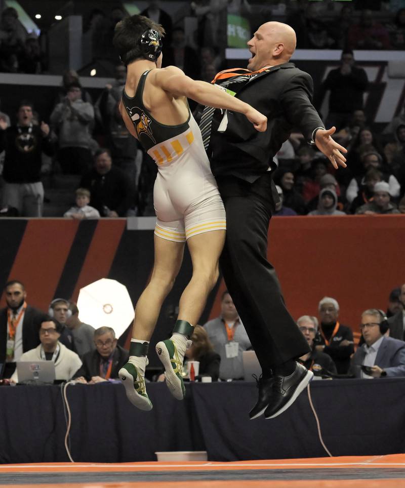 Fremd’s Evan Gosz jumps and chest bumps his coach after defeating Marmion’s Zach Stewart in the Class 3A 144-pound final at the IHSA boys state wrestling championships at the State Farm Center in Champaign on Saturday, Feb. 22, 2025.