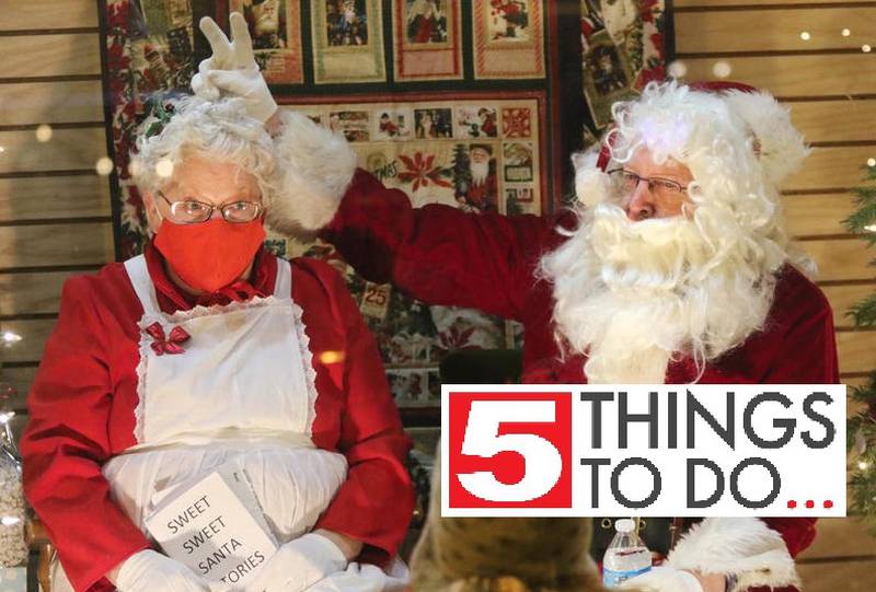 Nov. 20, 2020 file photo - Santa gives Mrs. Claus bunny ears as they visit with children through a store window during the Sycamore Chamber's Moonlight Magic event Friday Nov. 20 in downtown Sycamore.