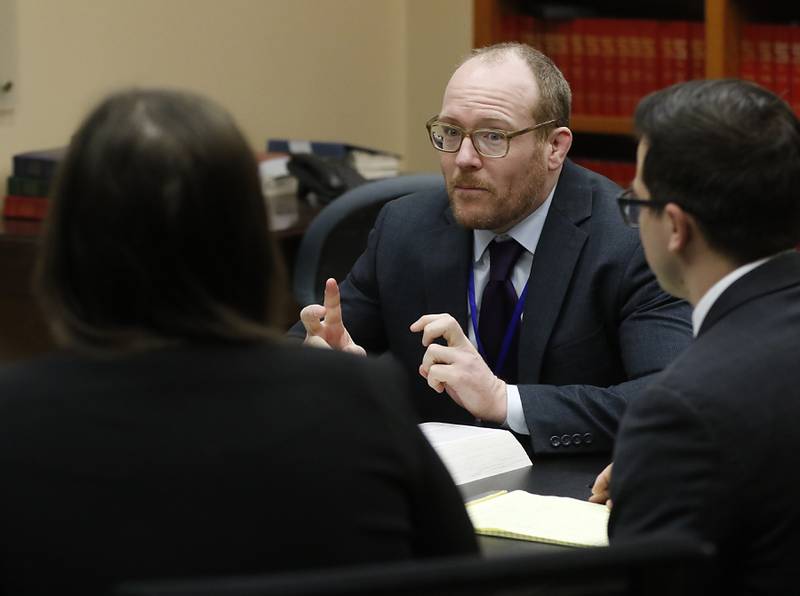 McHenry County State's Attorney Patrick Kenneally (center) talks with assistant state's attorneys Maria Marek (left) and Hunter Jones (right) Wednesday, Dec. 28, 2022, about changes implemented as a result of the SAFE-T Act at their office in the McHenry County Government Center in Woodstock.