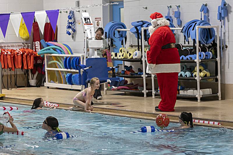Santa greets swimmers at the Dixon YMCA Thursday, Dec. 14, 2023.The Y brought in the Mr. Kringle as well as offering crafts and Christmas cookies.