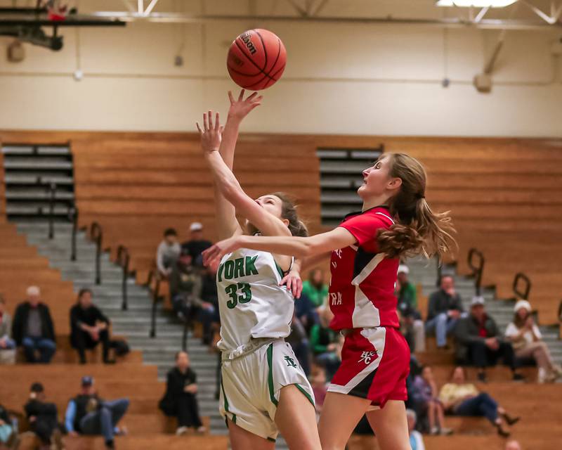 York's Kayla Callahan (33) puts up a shot over Hinsdale Central's Julia Sherpitis (11)  during basketball game between Hinsdale Central at York. Dec 8, 2023.