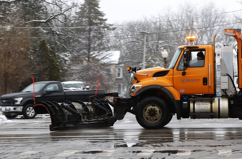 A Illinois Department of Transportation snow plow travels through Richmond as it clears snow of of U.S Route 12 in Richmond on Friday,  Dec. 9, 2022. Areas of McHenry County received a couple of inches on snow after a winter storm moved through the county.
