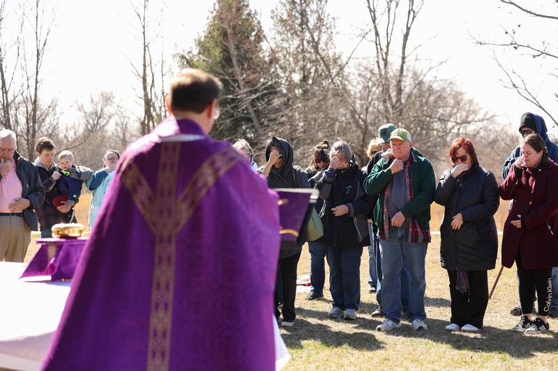 Area residents gather to participate in a Mass and prayer service held in Aroma Park on Thursday, March 12, 2026, following the EF-3 tornado that tore through the town and Kankakee County on March 10.