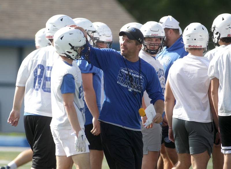 Geneva Head Coach Boone Thorgesen (center) chats with some of his team during the first day of practice for the fall season on Monday, Aug. 7, 2023 at the school.
