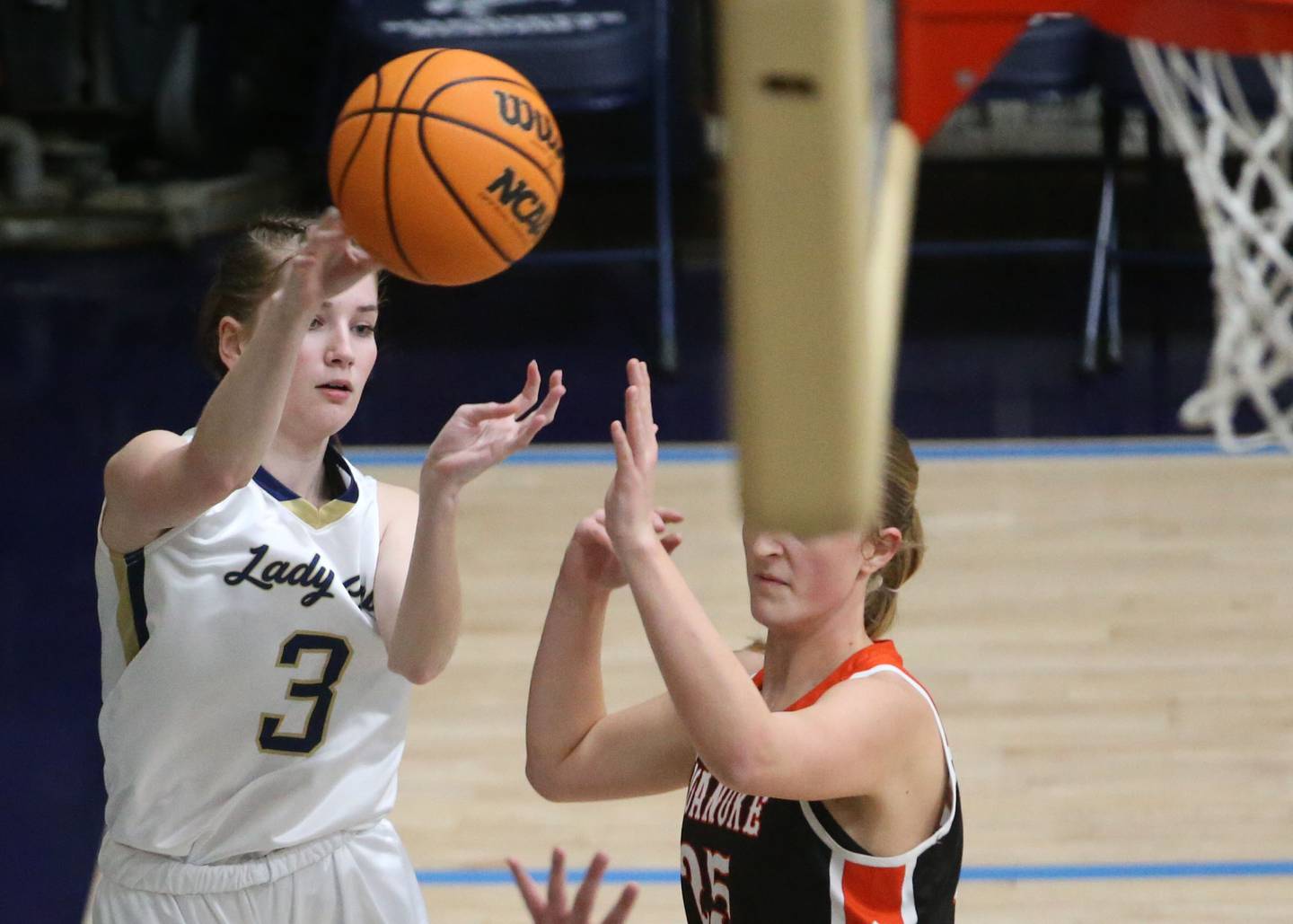 Marquette's Morfan Nelson passes the ball away from Roanoke-Benson's Callie Kennell on Thursday, Feb. 6, 2025 in Bader Gym at Marquette High School.