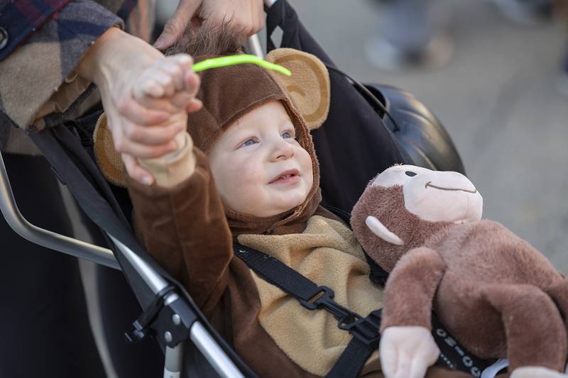 Weston Howard, 1, is lent a helping hand waving at admirers Saturday, Oct. 26, 2024, in Dixon.