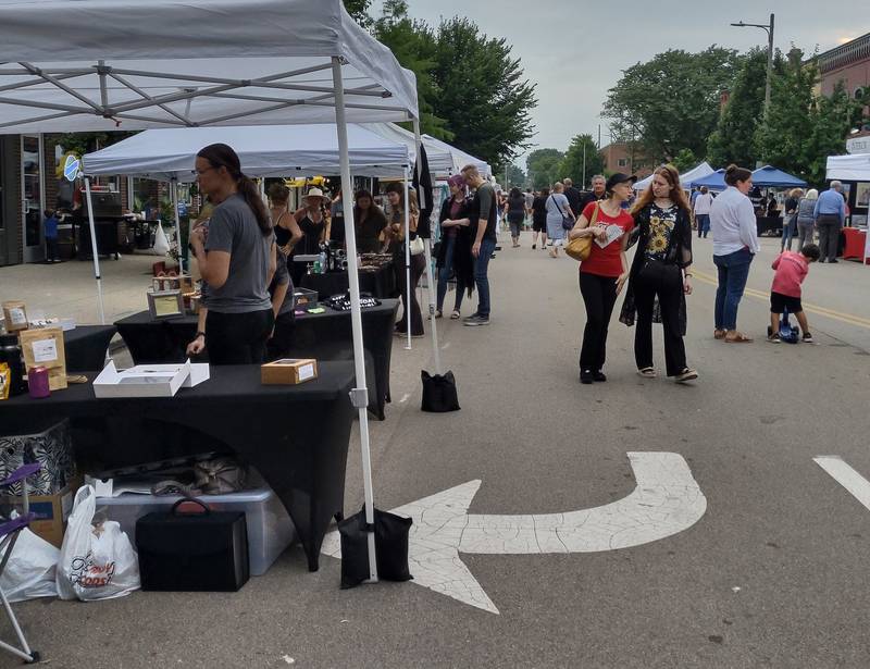 People stroll the Third Friday vendor market Friday, July 15, 2022, at Ottawa's Madison Street.