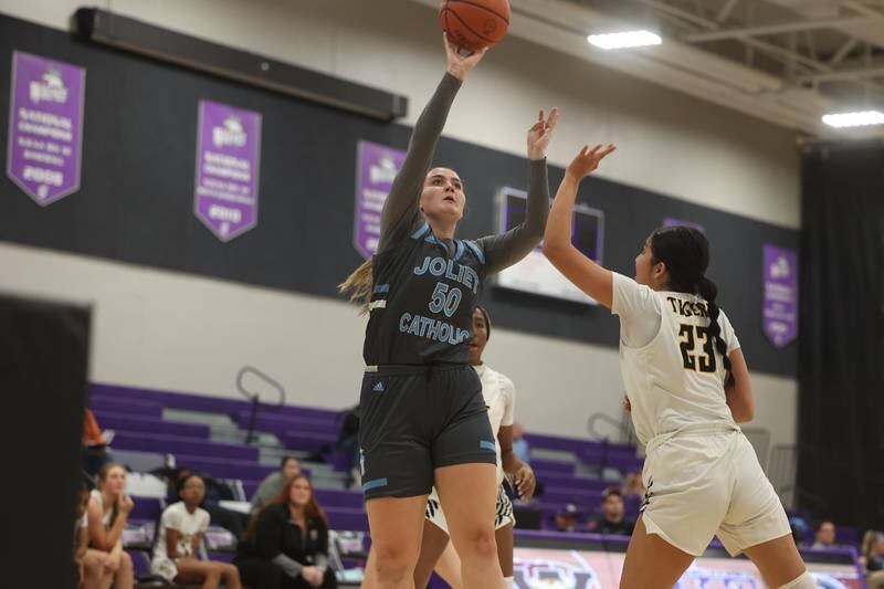 Joliet Catholic’s Faith Pietras puts up a shot against Joliet West in the WJOL Basketball Tournament at Joliet Junior College Event Center on Monday