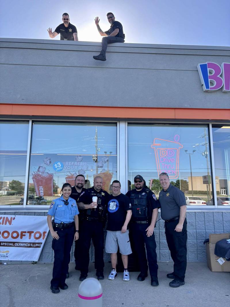 Members of the Yorkville Police Department greet members of the community while fundraising for the Special Olympics of Illinois during their annual 'Cop on a Rooftop' event at the Dunkin' locations in Yorkville.