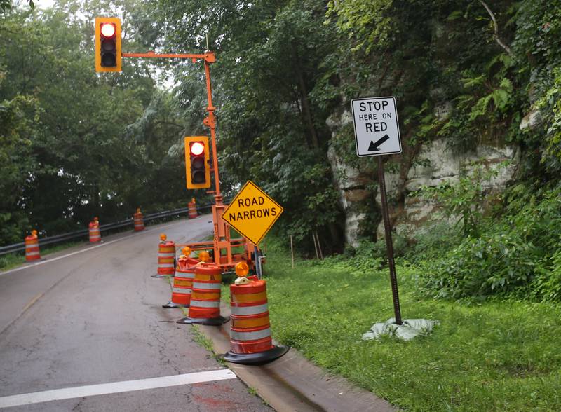 A temporary stop light is open to one-lane traffic as crews fix a retaining wall along Buffalo Rock's State Park entrance road on Monday, Aug. 14, 2023. The Illinois Department of Transportation announced more temporary closures for the park. The park will be closed Tuesday, Aug. 15, through Thursday, Aug. 17; Tuesday, Aug. 22, through Thursday, Aug. 24; Tuesday, Aug. 29, through Wednesday, Aug. 30; Tuesday, Sept. 5, through Thursday, Sept. 7; and Tuesday, Sept. 12, through Thursday, Sept. 14.