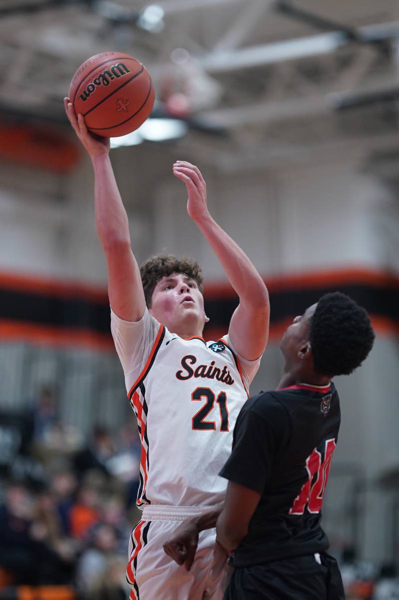 St. Charles East's Jacob Vrankovich (21) shoots the ball in the post against East Aurora's Davion Tidwell (10) during the 64th annual Ron Johnson Thanksgiving Basketball Tournament at St. Charles East High School on Monday, Nov 20, 2023.