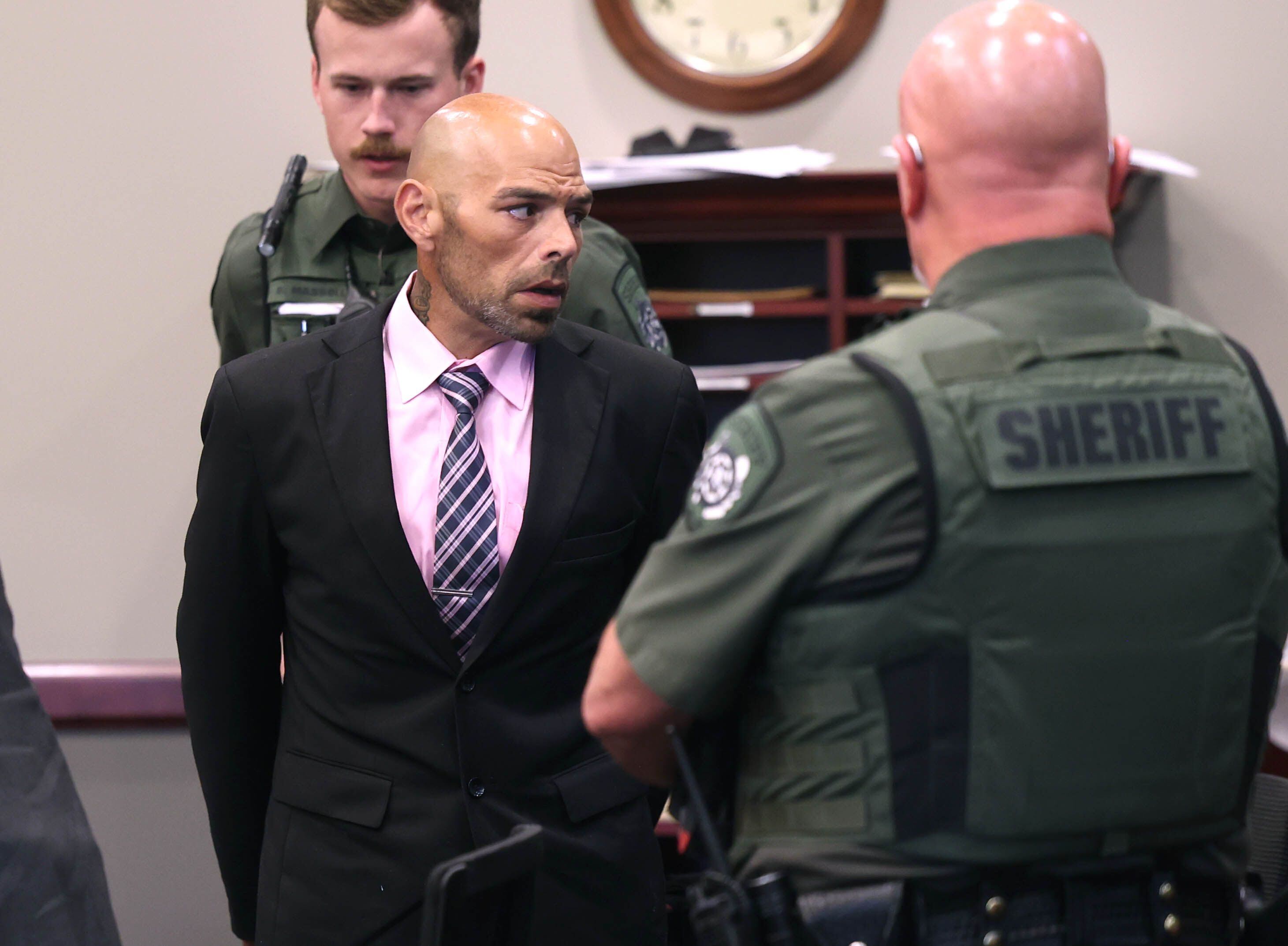 Nathan P. Sweeney talks to members of his family as he is cuffed by an Ogle County sheriff’s deputy Tuesday, Aug. 26, 2025, after his sentencing at the DeKalb County Courthouse in Sycamore. Sweeney received the maximum 14 years for driving under the influence and causing the 2024 crash that killed DeKalb County sheriff’s deputy Christina Musil.