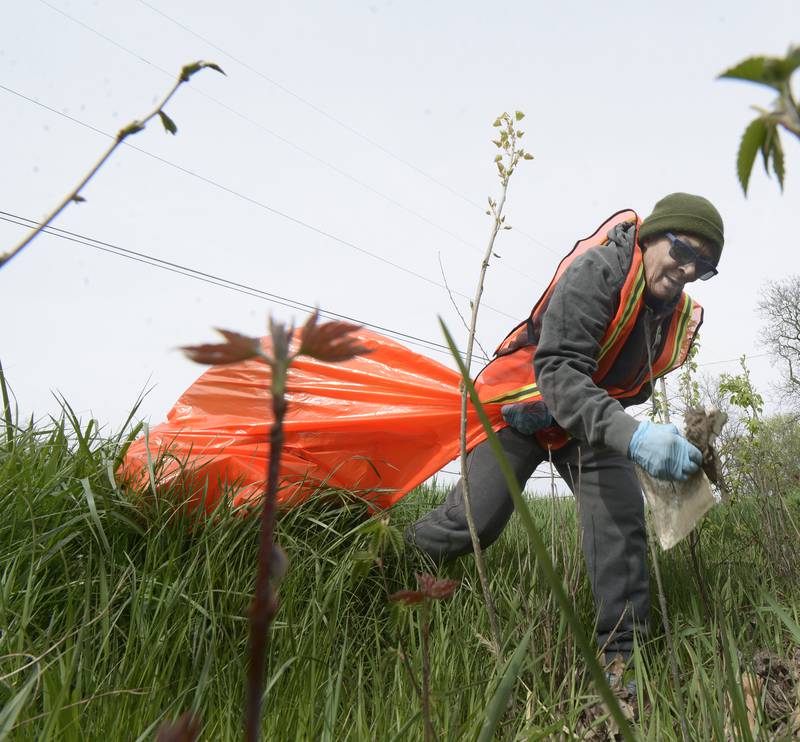 Onetti Huvvald walks through the weeds picking up trash along RT 6 west of Ottawa Monday during Operation Clean Sweep celebrating Earth Day.