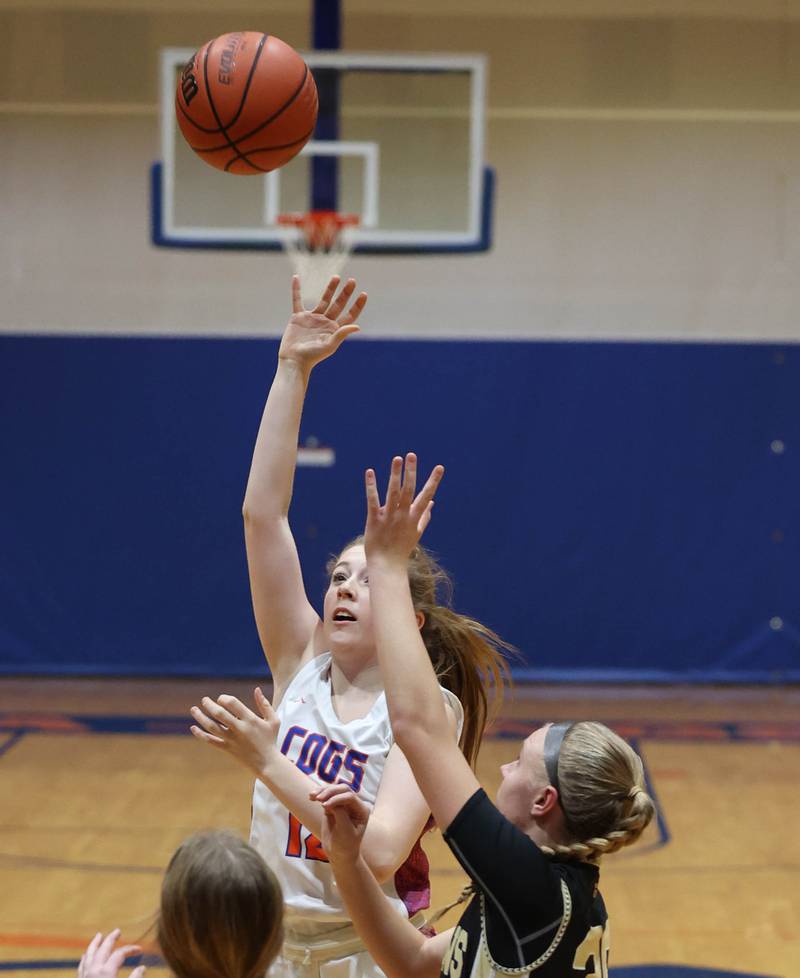 Genoa-Kingston's Ally Poegel shoots over two Rockford Christian defenders during their game Friday, Jan. 13, 2023, at Genoa-Kingston High School.