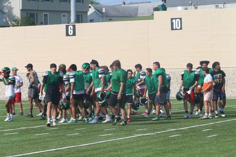 Members of the La Salle-Peru football team huddle at Howard Fellows Stadium during their football camp on Tuesday, July 25, 2023 in Peru.