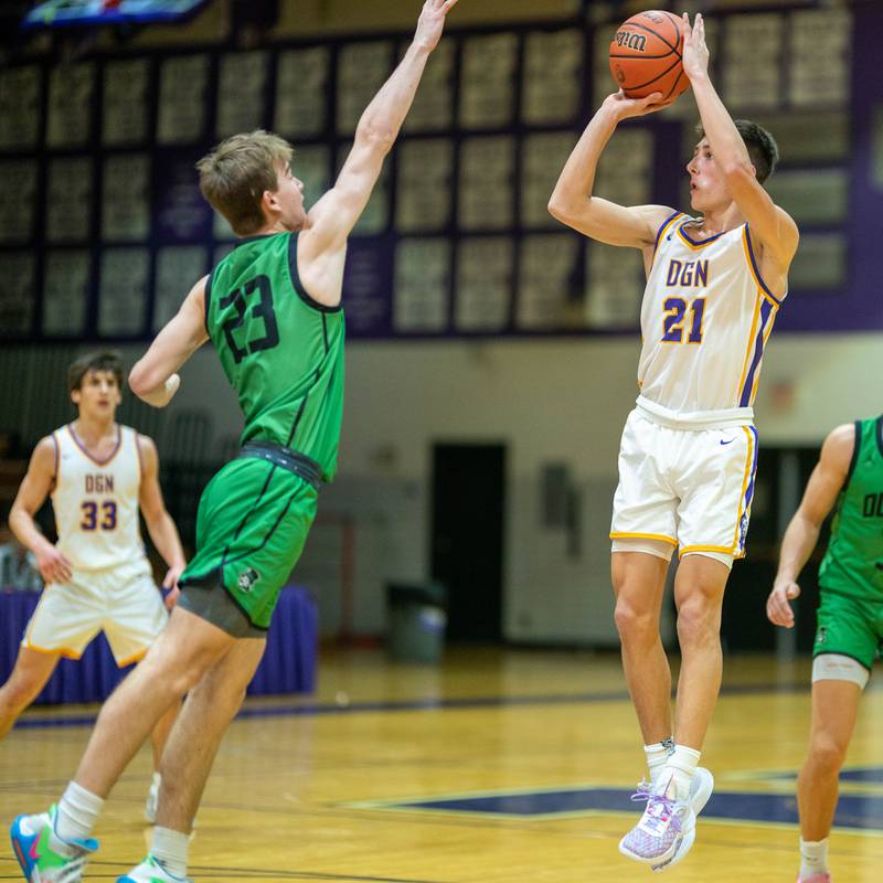 Downers Grove North's Jack Stanton (21) shoots the ball against York's Logan Rice (23) during a basketball game at Downers Grove North High School on Friday, Dec 9, 2022.