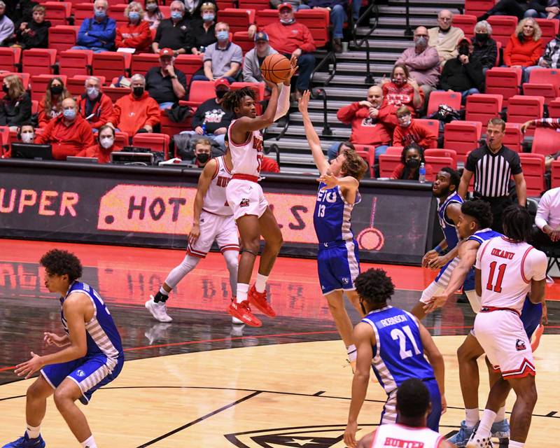 NIU guard Keshawn Williams,center, makes a basket on Tuesday Dec. 1st in the second half of the game while being defended by Eastern Illinois held in DeKalb.