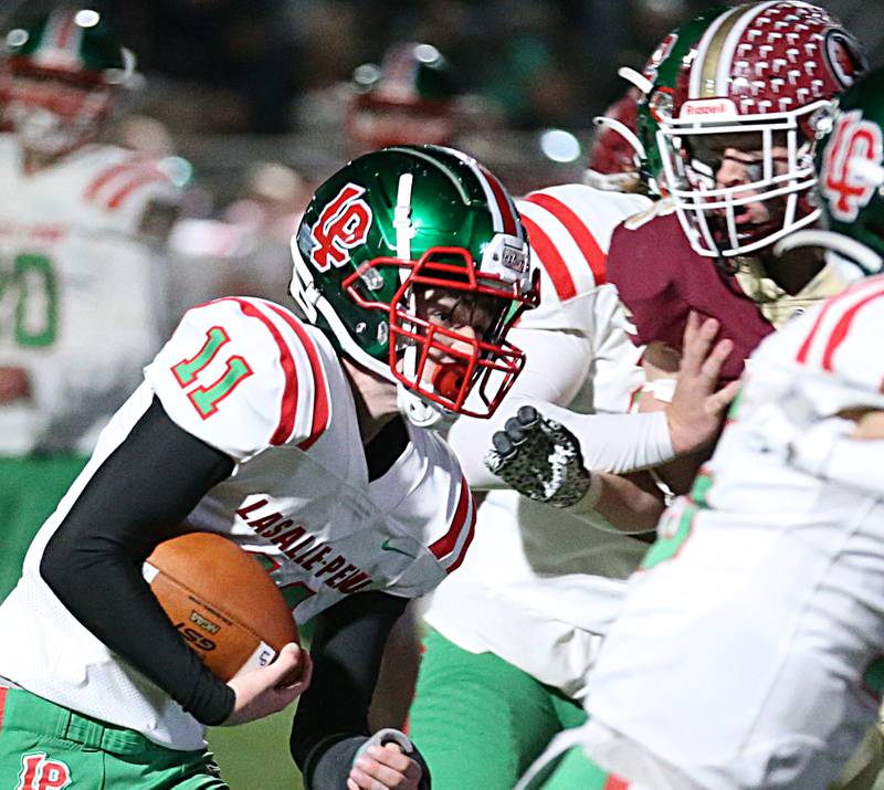 L-P's Kaleb Kennedy (11) runs the the ball against Morris during the Class 5A round one football game on Friday, Oct. 28, 2022 in Morris.