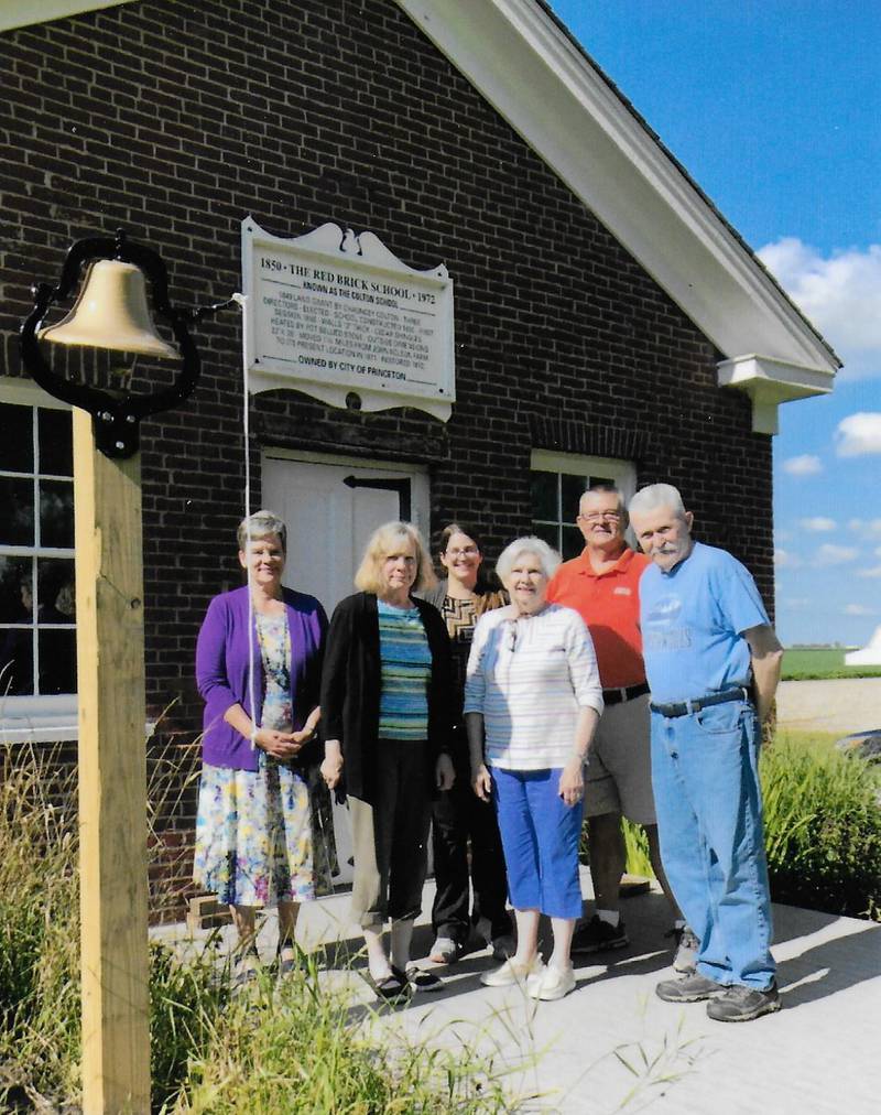 (From left) Lovejoy Homestead Board of Trustees members Sara Hudson, Pam Lange, Dana Fine, Ken Corban and docent Lois Peterson pose for a photo near the bell at Colton School on the Lovejoy Homestead in Princeton. Rob Jensen also is a member of the board.