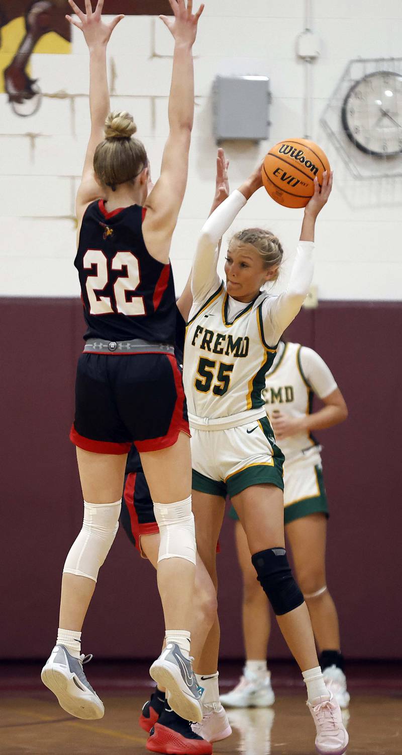 Fremd’s Greta Thompson (55) tries to find a teammate around Benet Academy's Bridget Rifenburg (22) during the Montini girls basketball Christmas tournament Saturday, Dec. 28, 2024 in Lombard.