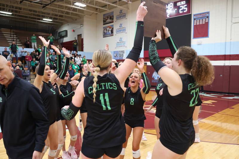Providence's Demi Carbone (8) rejoices with teammates as captains Abbey Knight (11) and Grace Lustig hoist the IHSA Class 3A Kankakee Sectional championship following the Celtics' victory in two sets, 25-25, 25-18, over Lemont in the on Thursday, Nov. 6, 2025.