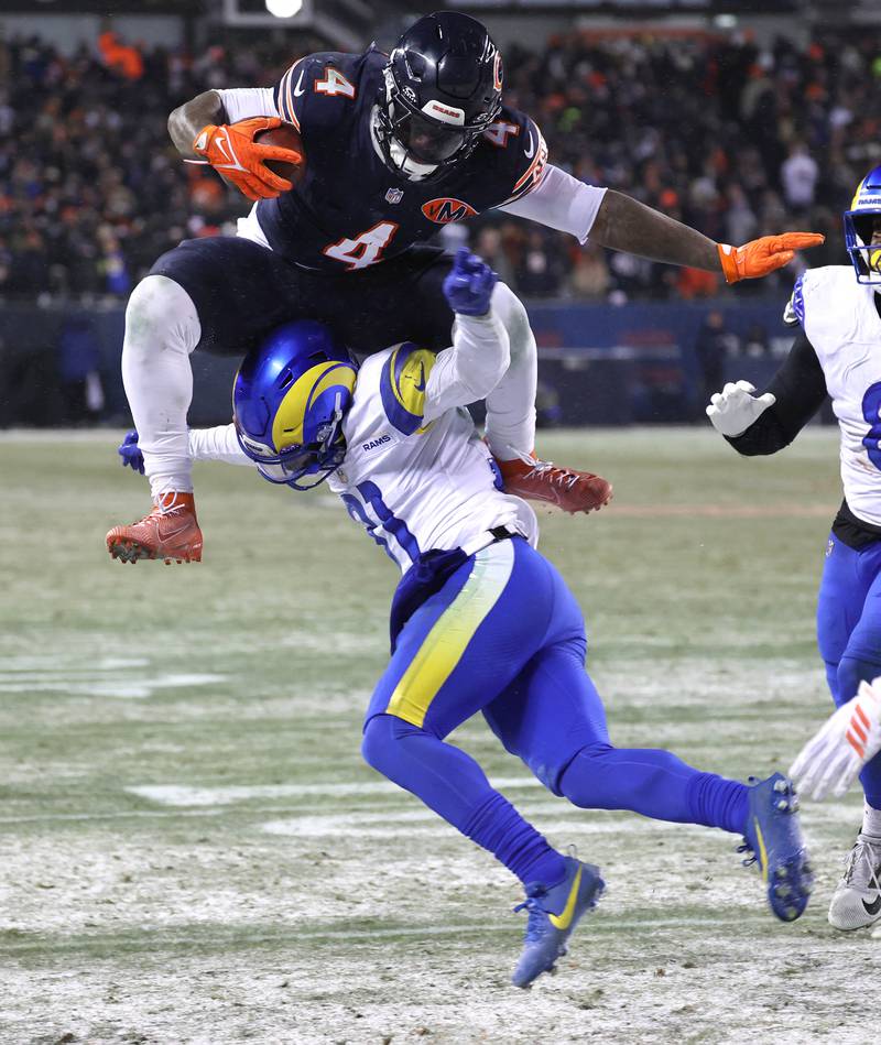 Chicago Bears running back D'Andre Swift hurdles Los Angeles Rams cornerback Darious Williams Sunday, Jan. 18, 2026, in their NFC divisional playoff matchup at Soldier Field in Chicago.