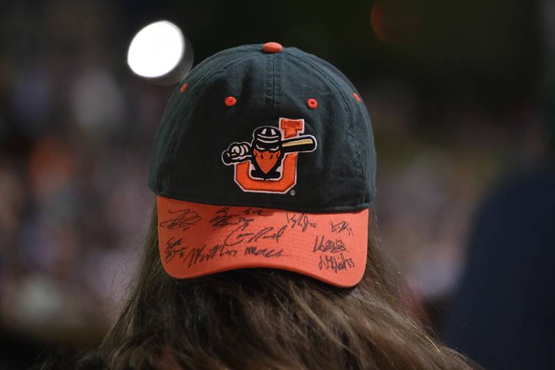 A fan wears a hat signed by the 2021 Joliet Slammers team at the home opener against the Ottawa Titans. Friday, May 13, 2022, in Joliet.