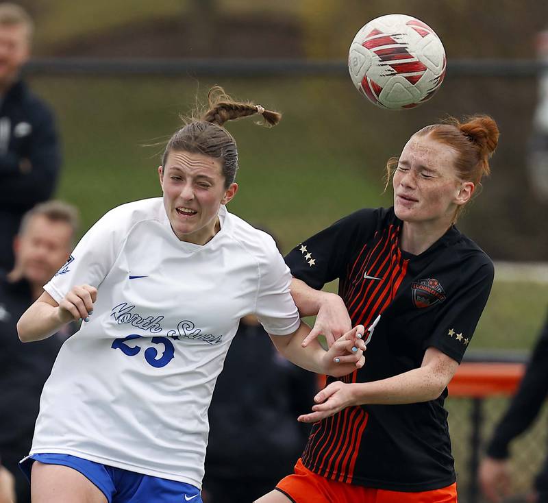 St. Charles North's Kaitlin Glenn (25) and St. Charles East's Reese Kyle (3) battle to head the ball during the championship game of the Rose Augsburg Drach Invitational Saturday, March 29, 2025 in St. Charles Ill.