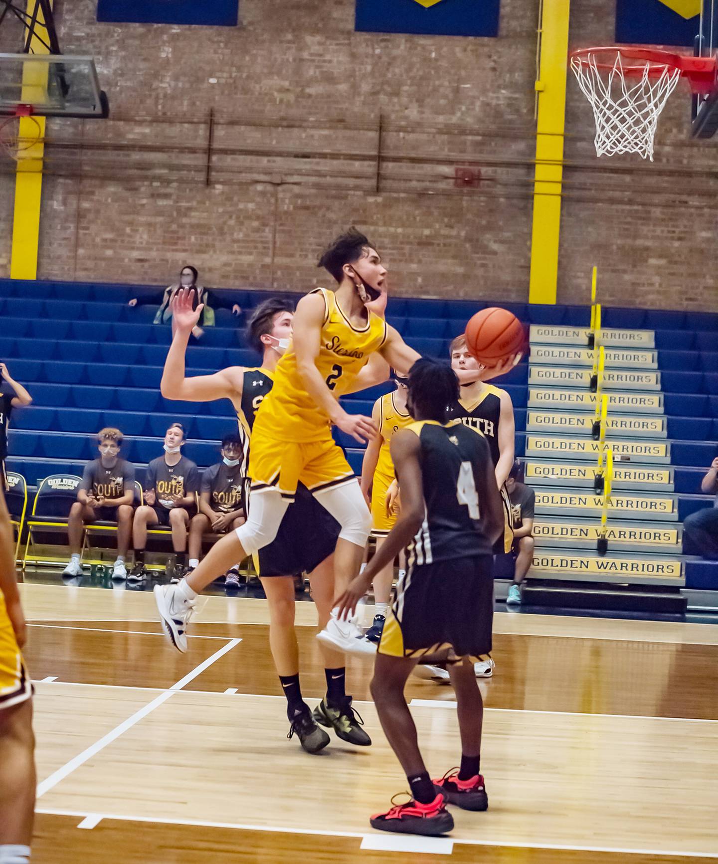 Sterling's JP Schilling (2) puts up a scoop shot between Hinsdale South defenders Brendan Savage and Deon Bomar (4) during their Sterling MLK tournament game Saturday evening at Musgrove Fieldhouse.