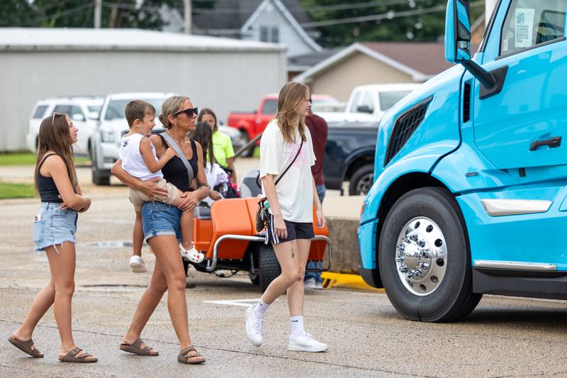 (left to right) Gianna Smith, Tara McLaughlin, Cruz McLaughlin and Mya McLaughlin look at semi trucks at the 21st annual Convoy Against Cancer on Saturday, July 19, 2025 on Main Avenue in Ladd.