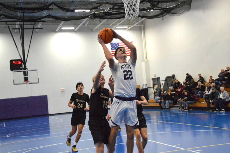 Rochelle's Holden Liebhaber scores and gets fouled, converting the three-point play, during the Hubs' sophomore basketball game with Sycamore.