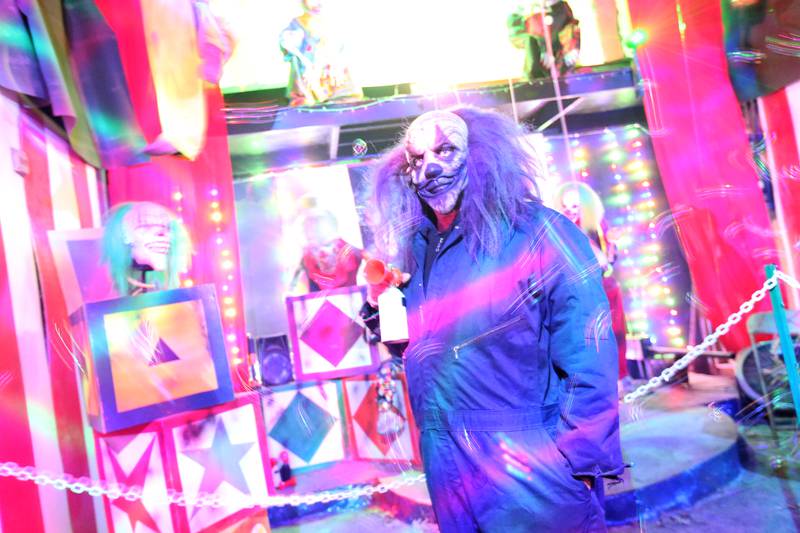 A scary character appears in a neon clown room during the Nightmare Haunted Attraction on Saturday, Oct. 14, 2023 at the Bureau County Fairgrounds in Princeton.