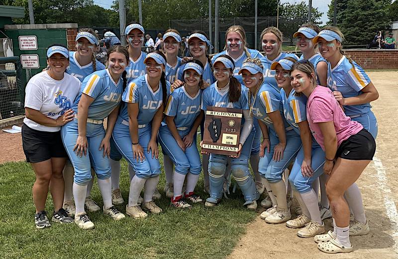 The Joliet Catholic Academy softball team shows off its plaque after winning the Class 3A Providence Catholic Regional with a 6-5 win in eight innings.