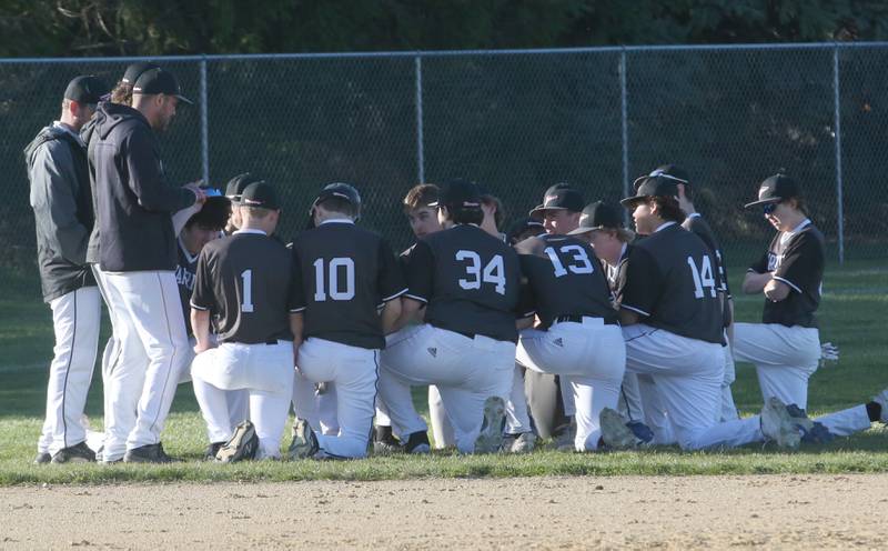 Members of the Woodland/Flanagan-Cornell baseball team gather in the outfield on Tuesday, April 9, 2024 at Woodland High School.