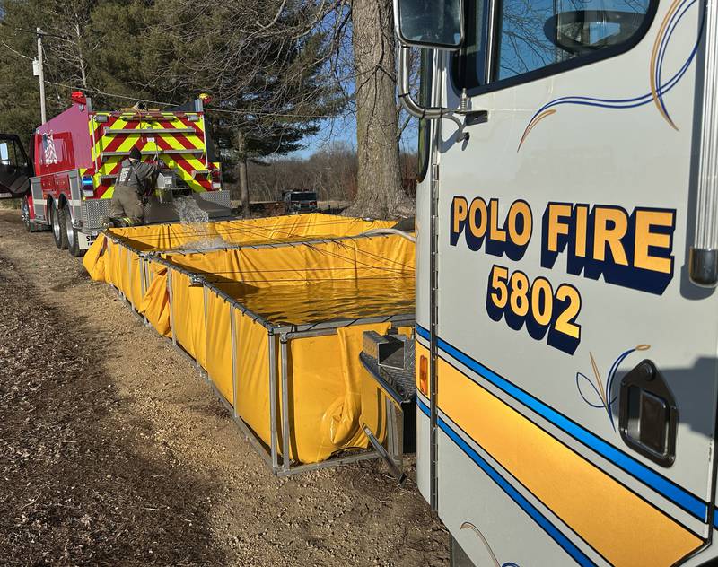 Firefighters from several departments responded to a field and hay bale fire at a farm on West Pines Road between Polo and Oregon on Monday, Feb. 23, 2026. Here, water is pumped into a portable water tank for the Polo engine to supply hoses.