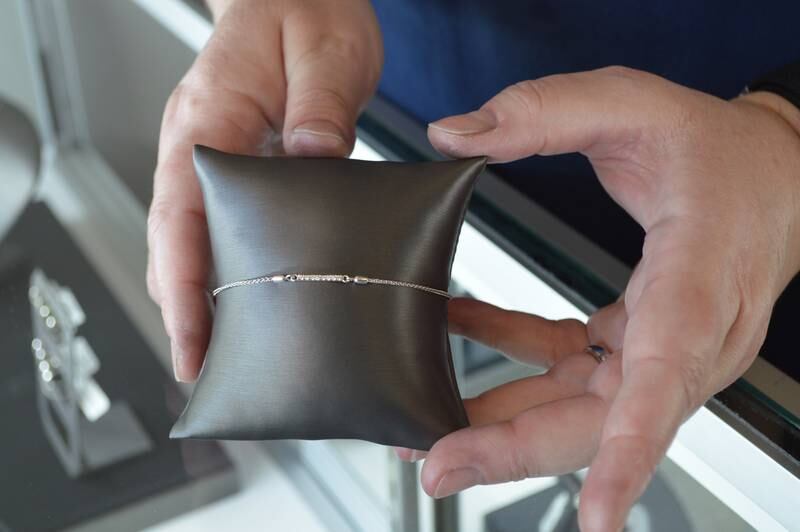 Jen Brooks, owner of Brooks Jewelers, shows off a sterling silver bracelet with lab-created diamonds and a bolo-style clasp that she made. Brooks Jewelers is located in downtown Oregon.