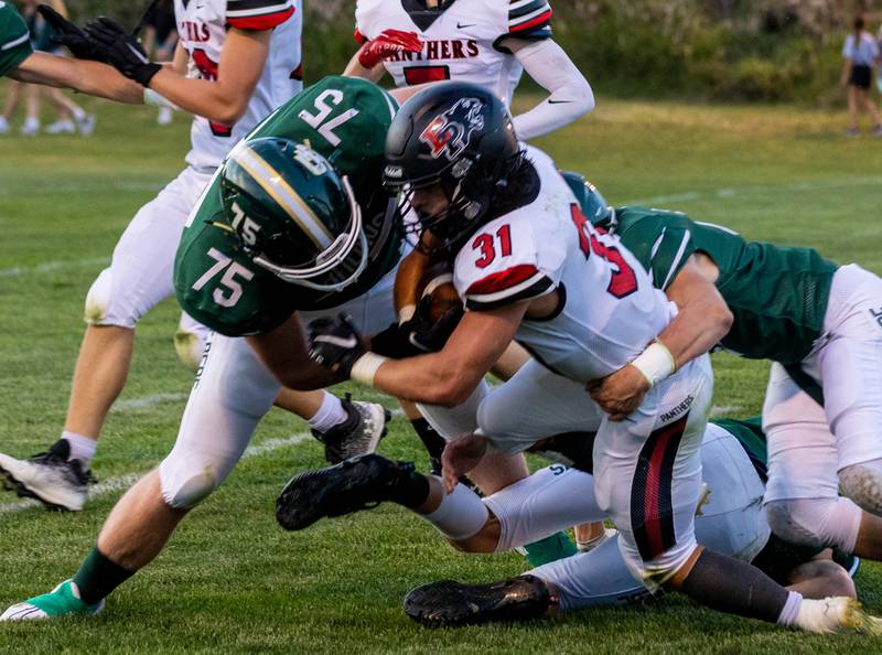 St. Bede's Ryan Migliorini (75) tackles Erie-Prophetstown's Jase Grunder on Friday, Sept. 2, 2022 in Peru.