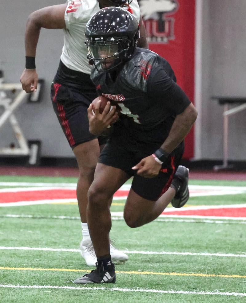 Northern Illinois’ Kenji Lewis carries the ball Wednesday, July 30, 2025, at the teams first practice of the season in the Chessick Practice Center at NIU in DeKalb.