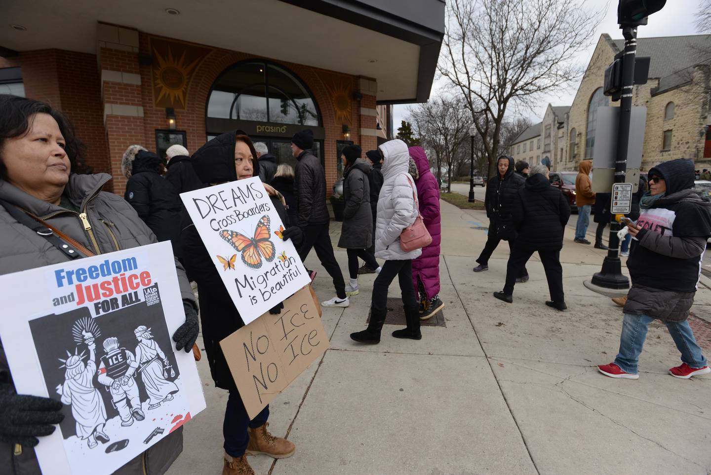 Bridgeview residents Martha Munoz (left) and Olivia Morgucz participate Sunday in a Silent Walk and Vigil in LaGrange in memory of Renee Nicole Good, who was fatally shot by an ICE agent in Minneapolis