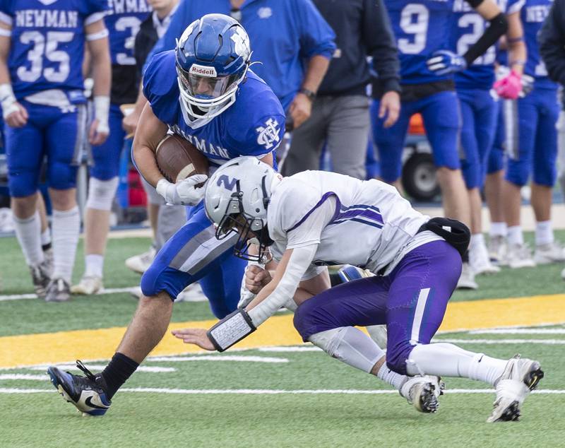 Newman’s Danny Welty picks up yards after the catch against Ridgeview-Lexington’s Blaine Friendmansky Saturday, Nov. 1, 2025, in round one of the Class 2A football playoffs.