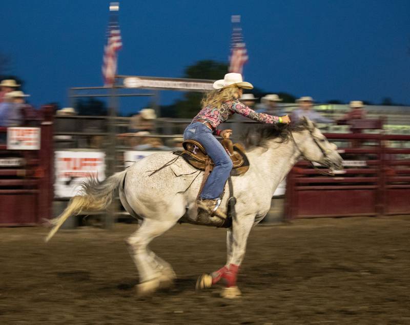 A barrel racer rides around the arena at the Tuff Hedeman Tour during the 75th Anniversary of the McHenry County Fair in Woodstock on Friday, August 4, 2023.