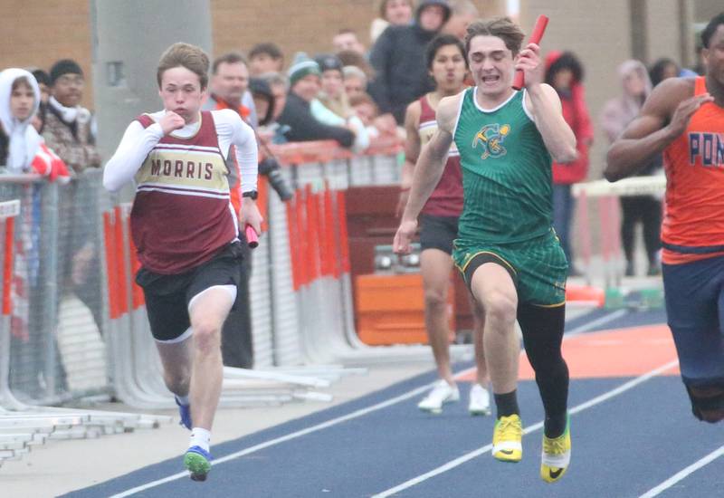Morris's Sawyer Ellenwood and Coal City's Alexander Collins compete in the 4x100 relay during the Class 2A Sectional meet on Wednesday, May 21, 2025 at Pontiac High School.