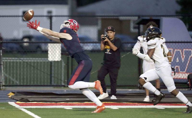West Aurora's Andrew Kollch (2) tries to reel in a pass over Joliet West's Billy Bailey Jr. (2) Thursday September 15, 2022 in Aurora.