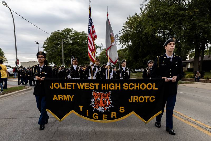 Kamiah Huffman and Ezekiel Pelzer carry the JROTC banner as the Joliet West homecoming parade travels down Glenwood Ave. in Joliet on Oct. 10, 2025.