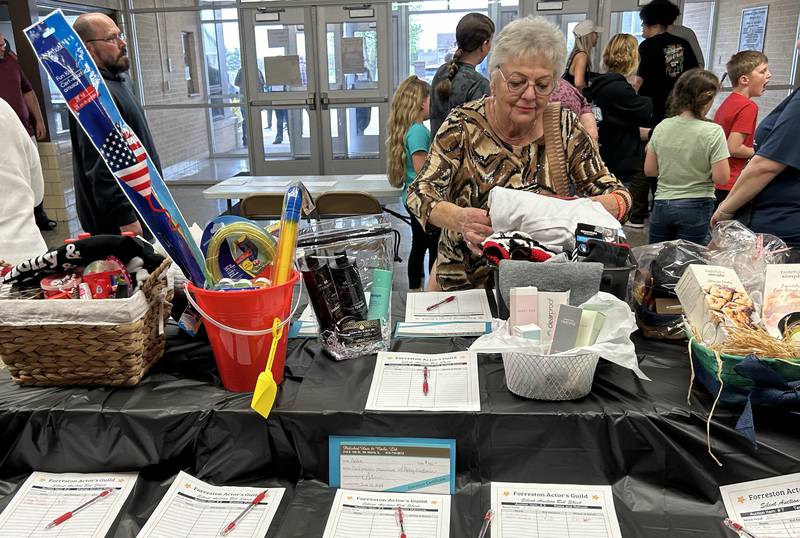 WIlma Akins of Forreston looks over the silent auction items for sale during intermission of the Forreston High School's performance of Annie on Sunday, April 28, 2024.  Money raised from the auction will be used to help pay for future projects and supplies.