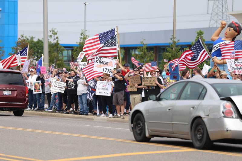 Hundreds of people gathered at the intersection of Larkin Avenue and West Jefferson Street in Joliet as part of the nationwide No Kings Day protests on Saturday, June 14, 2025. Organizers estimated 600 people attended the Joliet event.