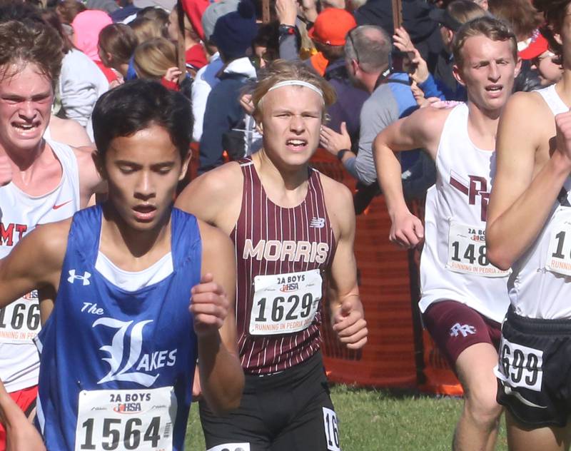 Lake Villa Lake's Blake Salbilla, Morris's Nikita Hovious and Prairie Ridge's Steven Randles competes in the Class 2A State Cross Country race on Saturday, Nov. 4, 2023 at Detweiller Park in Peoria.